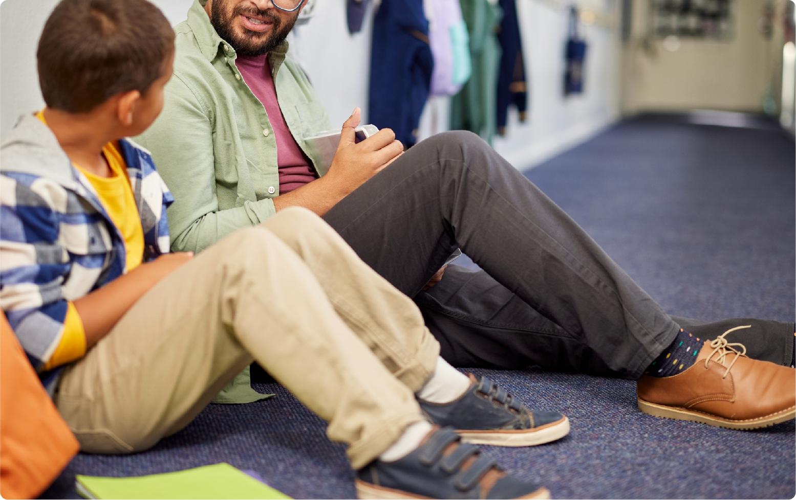 Young boy sitting on floor with legal advocate.